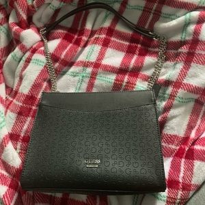 Black in black Guess purse, with adjustable black with silver chain